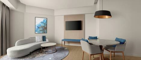 Una sala de estar moderna con un sofá, una mesa de centro, una mesa de comedor y sillas. Hay un televisor de pantalla plana montado en la pared y una lámpara colgante sobre la mesa de comedor.