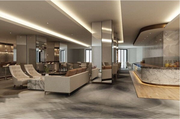 A modern hotel lobby with a reception desk, seating area, and a large mirror. - Putrajaya Marriott Hotel (Serdang)