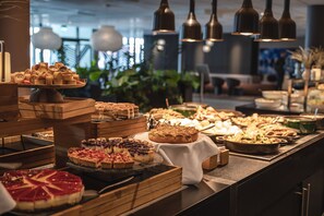 Un bufé con diversos postres y pastelería.