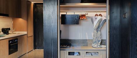 A modern kitchen with a built-in oven and a dark wooden cabinet.