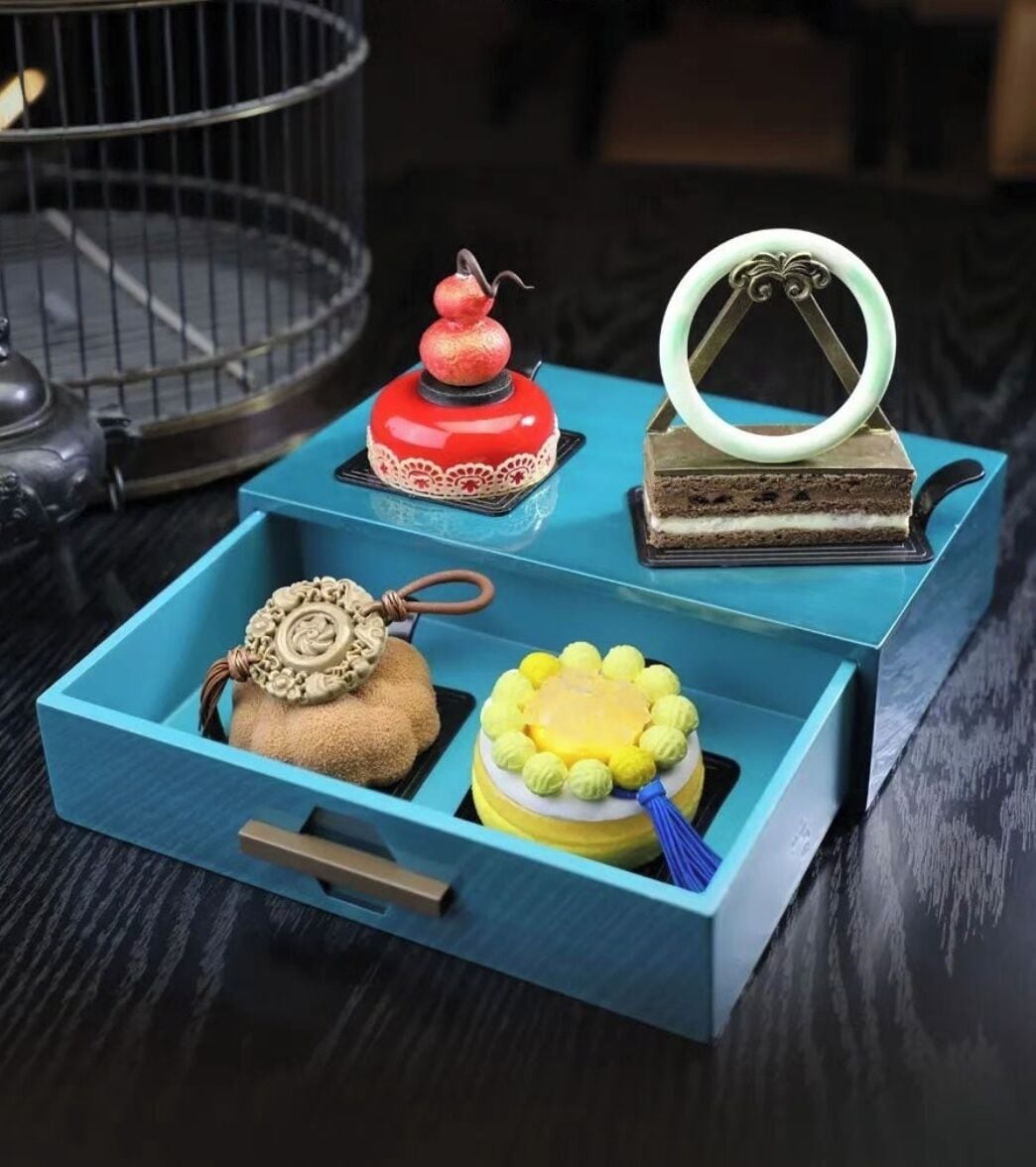 A blue storage box with compartments containing various items.