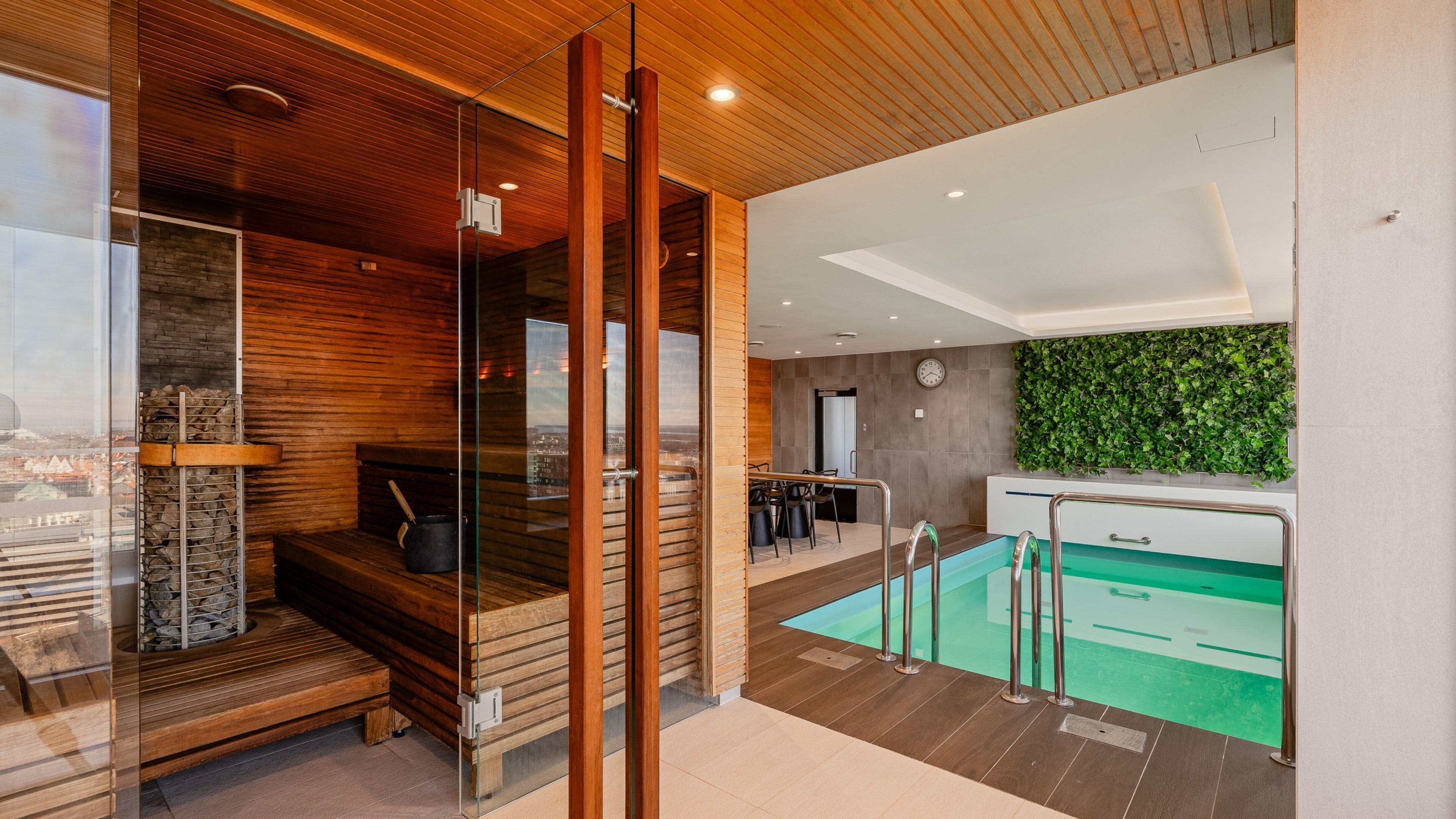 A modern interior with a sauna, a dining area, and a pool.