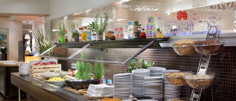 A buffet with various food items and dishes.