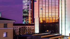 A modern hotel with a prominent 'OLÜMPIA' sign, featuring a grid-patterned facade and illuminated windows. - Radisson Blu Hotel Olumpia (Tallinn)