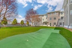A residential building with a green lawn and trees. - MainStay Suites Madison Airport (Madison)