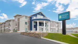 A hotel with a blue and white facade, a balcony, and a sign for MainStay Suites. - MainStay Suites Madison Airport (Madison)