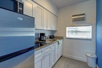 Efficiency King Deluxe | Private kitchen | Fridge, microwave, coffee/tea maker, cleaning supplies at Blue Strawberry by the Sea