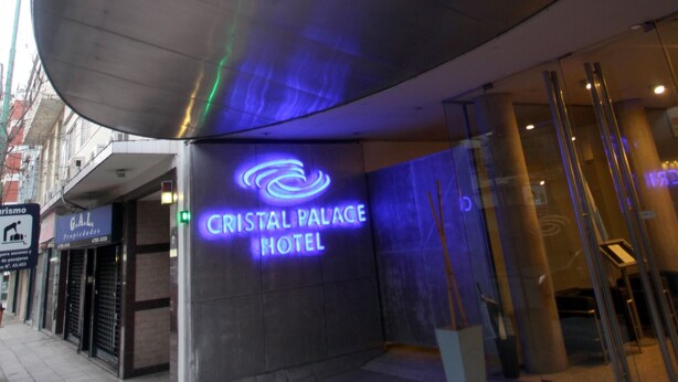 The exterior of the Cristal Palace Hotel with a prominent neon sign, large glass entrance, and a modern architectural design. - Cristal Palace Hotel (Buenos Aires)