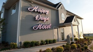 A two-story building with a sign reading "Happy Days Hotel". - Motel 6 McAlester, OK - South (McAlester)