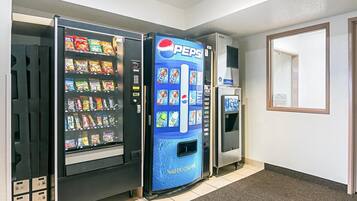 A vending machine area with a Pepsi machine and a selection of snacks and drinks.