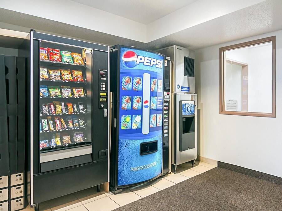 A vending machine area with a Pepsi machine and a selection of snacks and drinks.