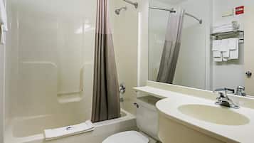 A bathroom with a bathtub, toilet, and sink.