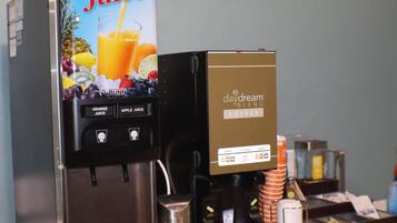 A juice dispenser with options for orange and apple juice, and a coffee machine labeled 'daydream blend coffee.'