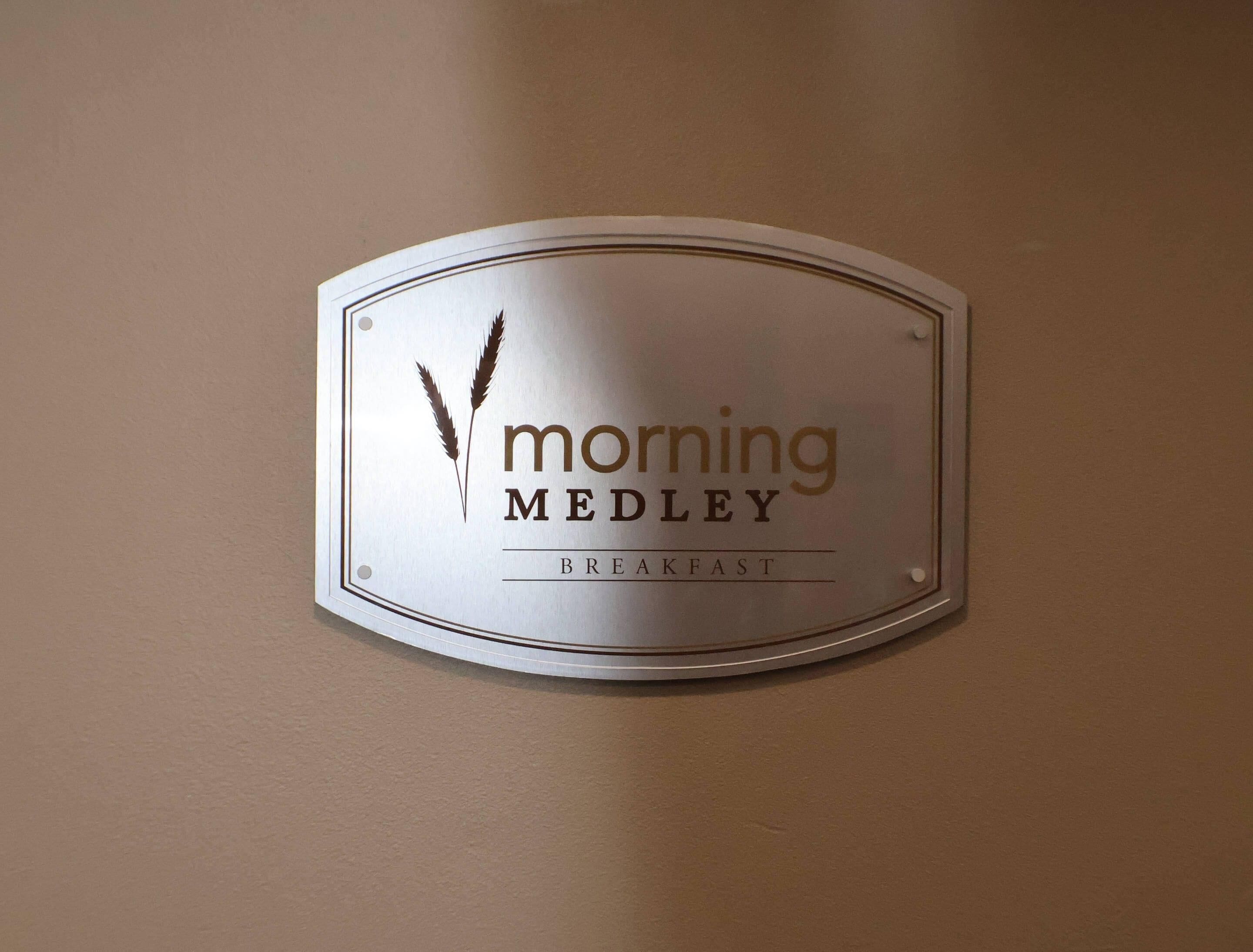 A sign with the text 'morning Medley BREAKFAST' on a wall.