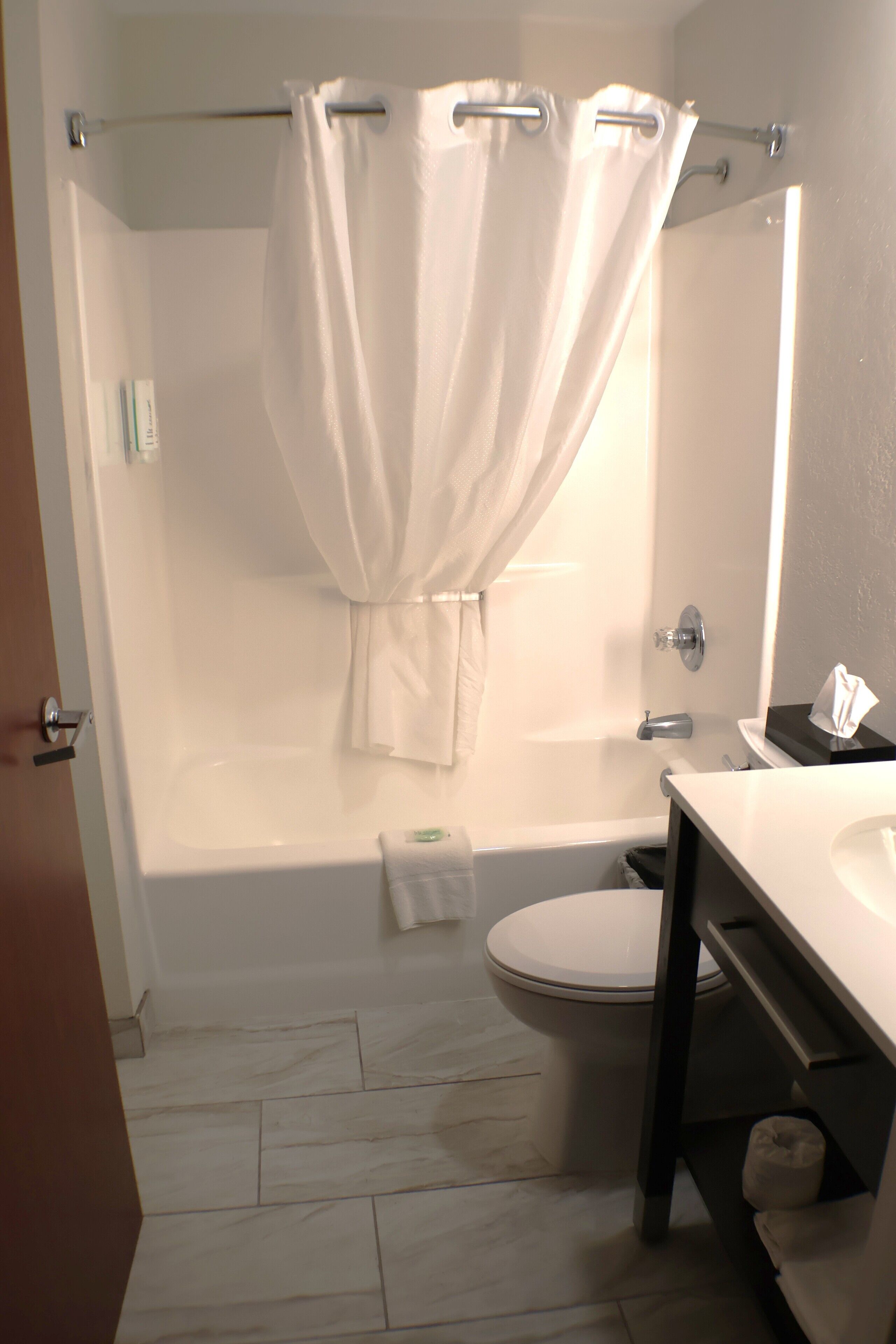 A bathroom with a bathtub, toilet, and sink.