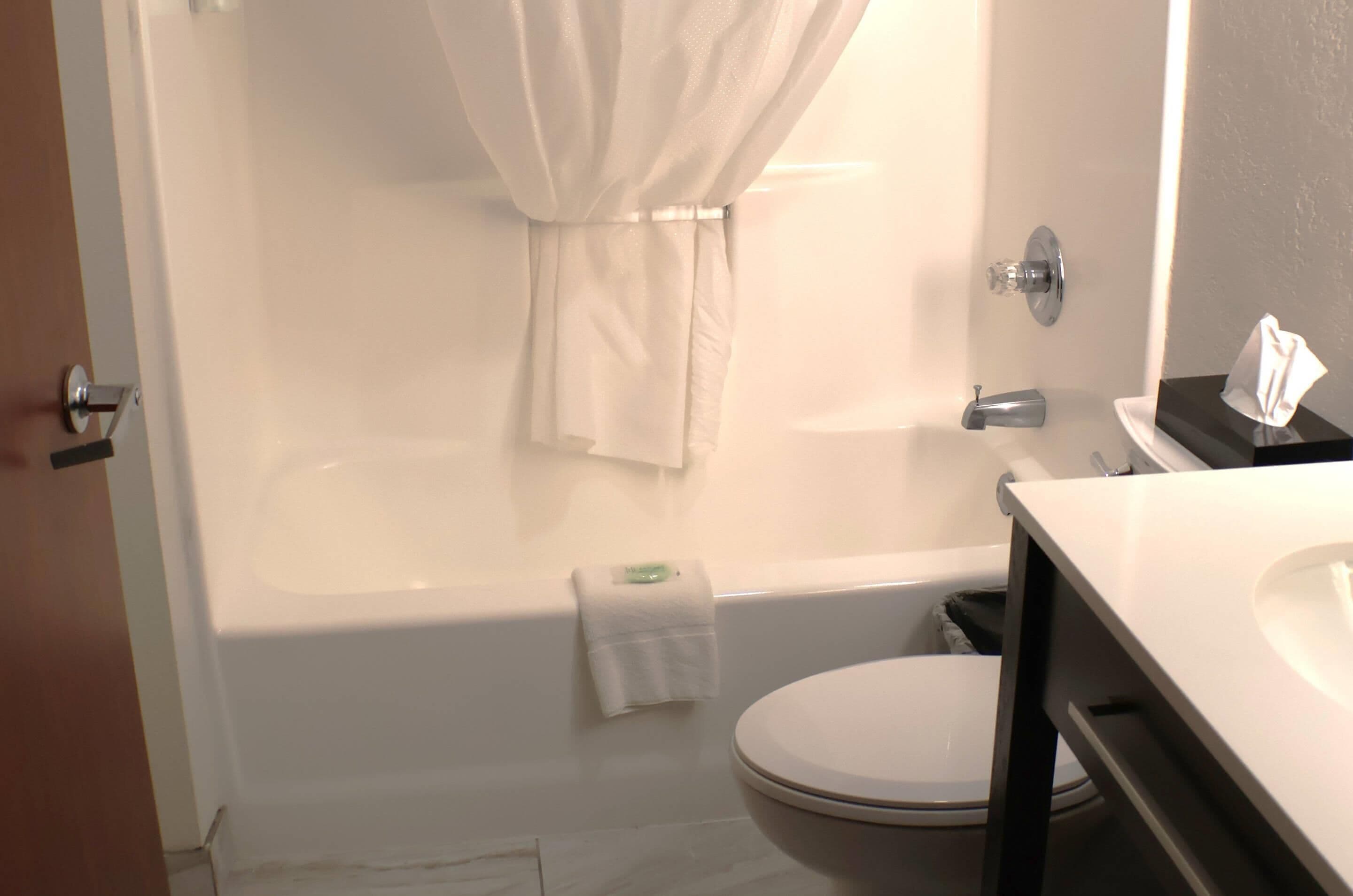 Un baño con bañera, inodoro y lavamanos.