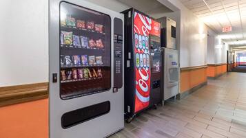A vending machine area with a Coca-Cola branded machine and a 'FUSH' branded machine.