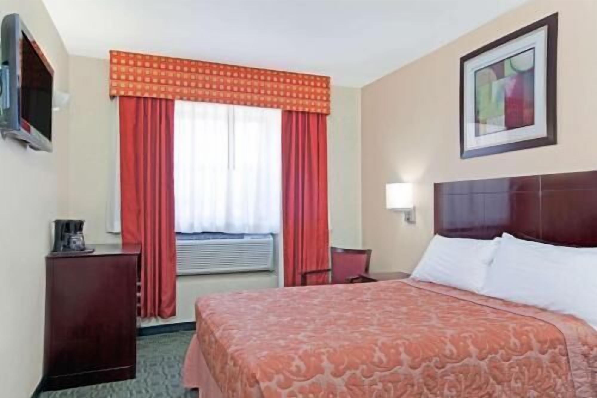 Hypo-allergenic bedding, desk, laptop workspace, blackout drapes