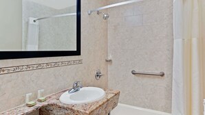 A bathroom with a sink, mirror, shower, and handrails. - Super 8 by Wyndham Long Island City LGA Hotel (Astoria)