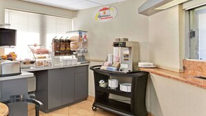 A breakfast area with a coffee machine, a fruit display, and a sign for 'Superstart breakfast'. - Super 8 by Wyndham Long Island City LGA Hotel (Astoria)