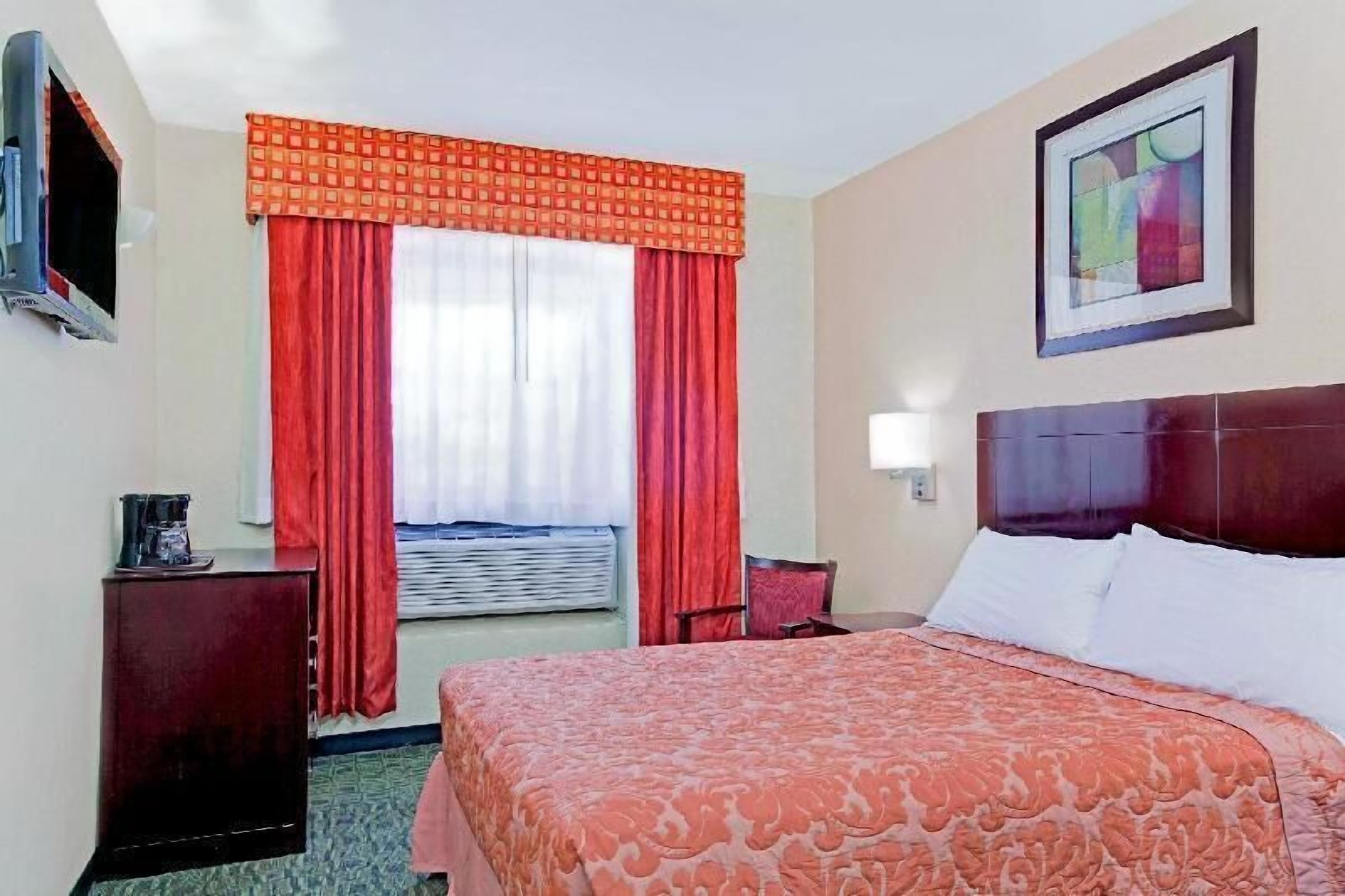 Hypo-allergenic bedding, desk, laptop workspace, blackout drapes