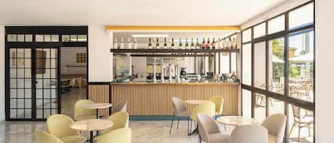 A modern bar area with a variety of seating options and a wine display.