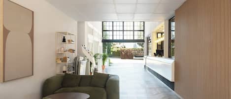 A modern interior with a sofa, a small table, and a bookshelf.