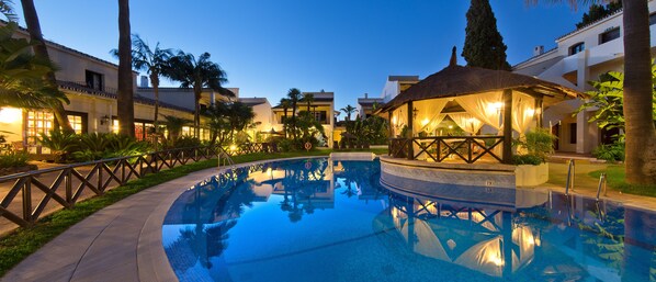 Seasonal outdoor pool, open 11:00 AM to 7:00 PM, pool umbrellas