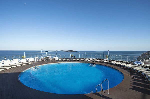 Outdoor pool, open noon to 6:00 PM, pool loungers