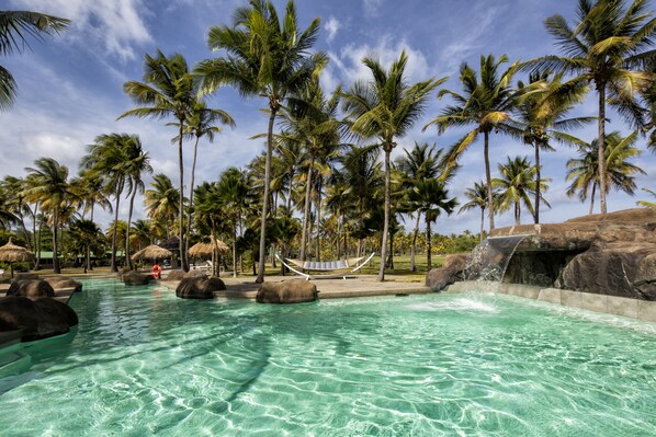 Outdoor pool, a waterfall pool, pool umbrellas, pool loungers