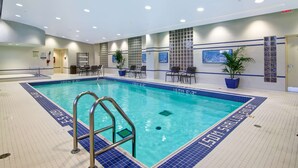 An indoor swimming pool with a clear water view, surrounded by tiled walls and a ceiling with recessed lighting. - Hilton Garden Inn Toronto/Markham (Markham)
