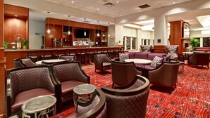 A hotel lobby with seating areas, a bar, and a television screen. - Hilton Garden Inn Toronto/Markham (Markham)