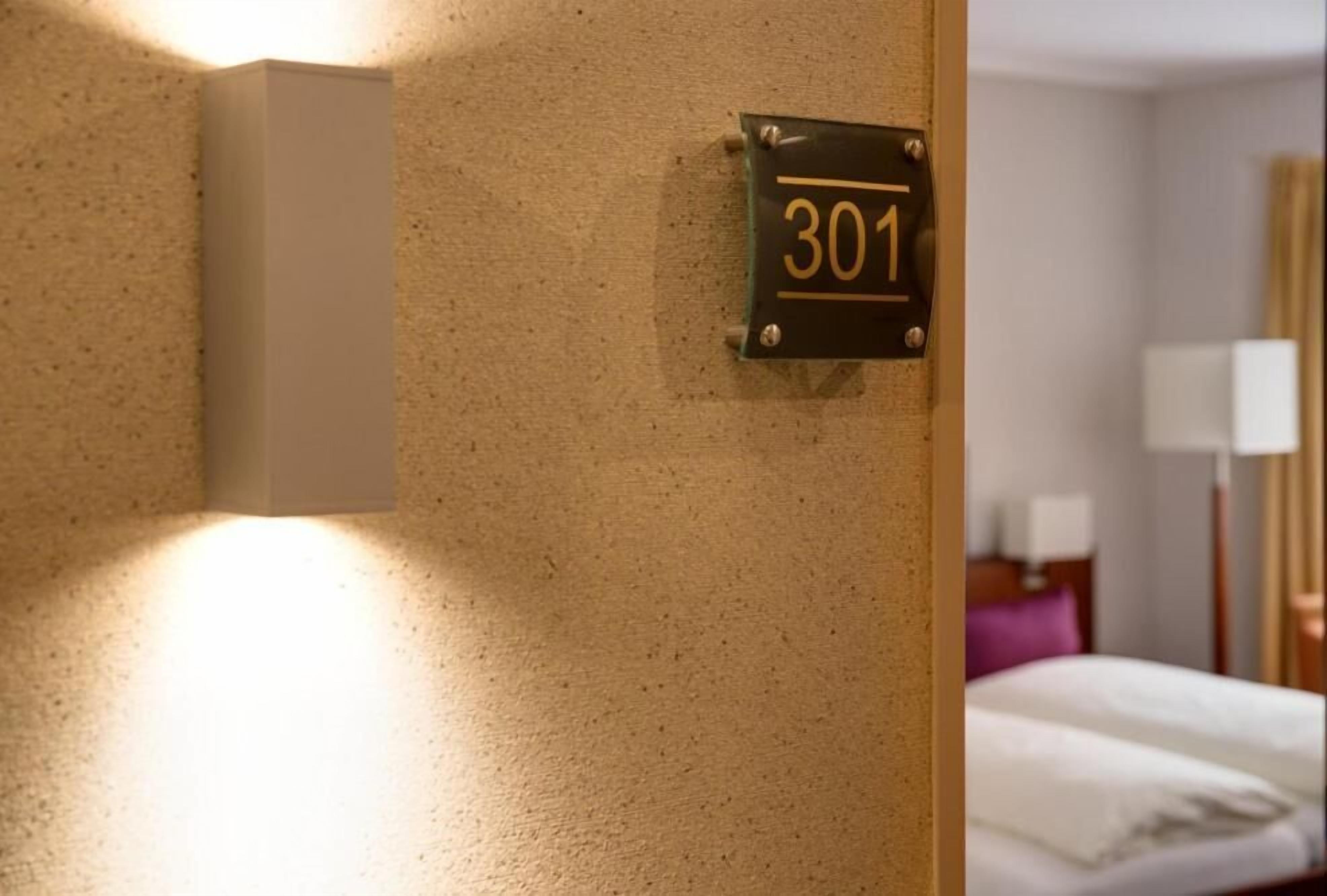 A wall-mounted sign with the number 301, indicating a room or section number.