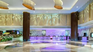 A spacious lobby with a reception desk, seating area, and a large column. - Crowne Plaza Guangzhou City Centre by IHG (Guangzhou)