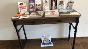A wooden desk with brochures and a travel rewards award on it. - Sleep Inn Louisville Airport (Louisville)
