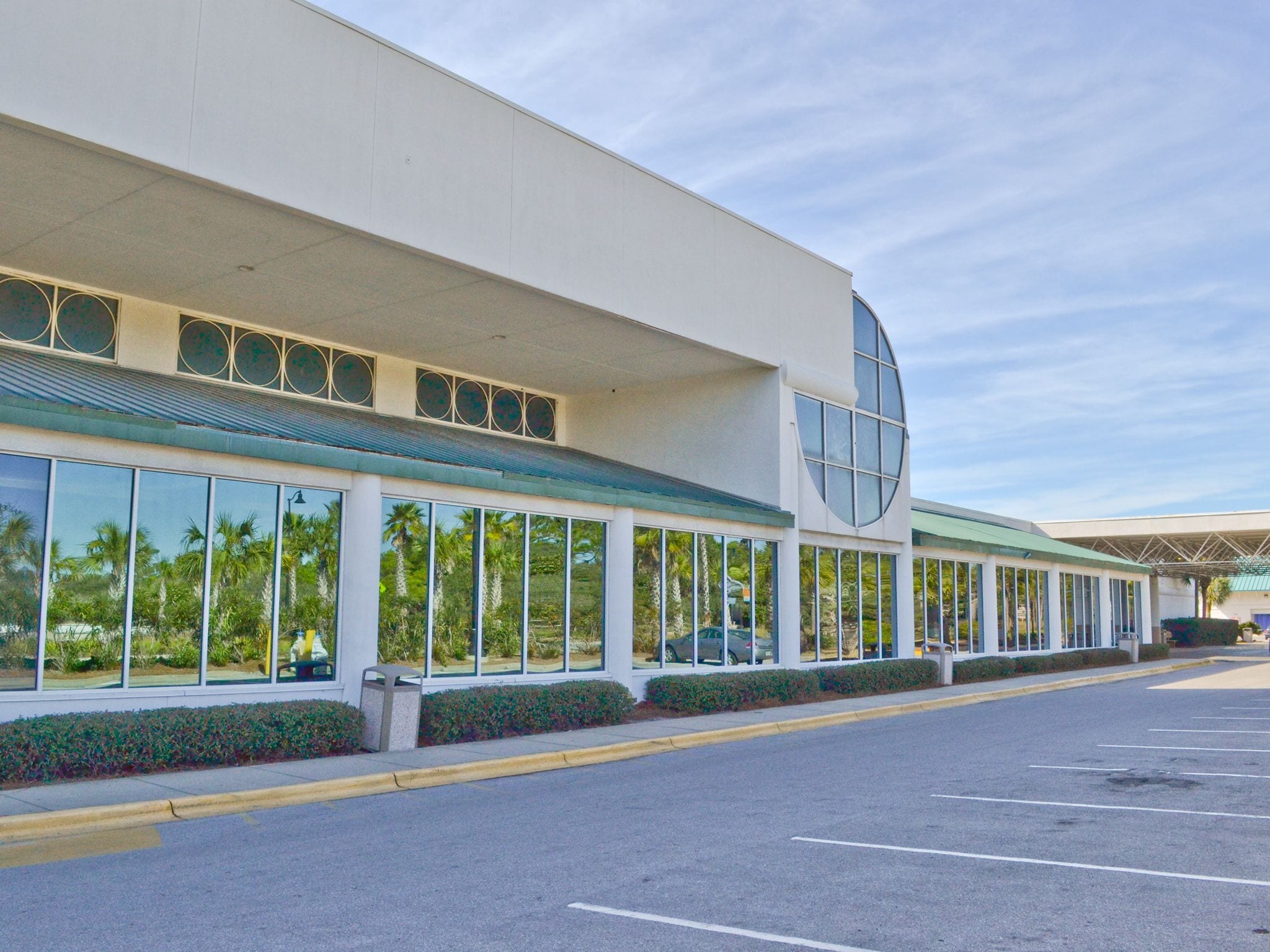 A modern building with large windows and a curved glass section.
