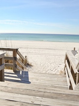 Private beach, white sand, sun loungers, beach umbrellas at Boardwalk Beach Hotel
