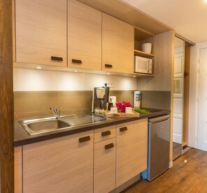 Mini-fridge, microwave, electric kettle, cookware/dishes/utensils