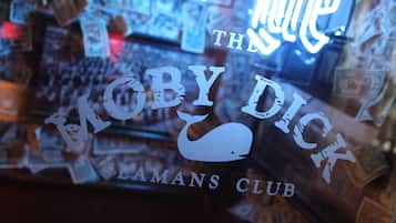 A bar with a sign reading "The Mobydick Club."