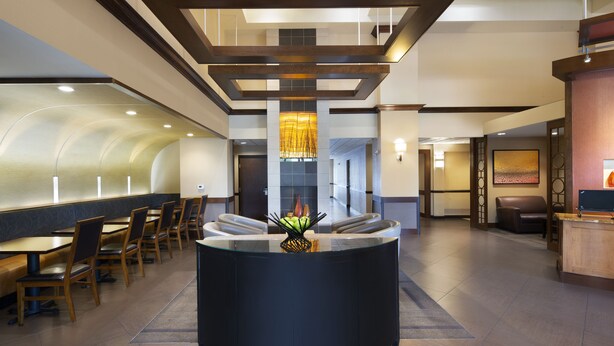 A modern hotel lobby with a reception desk, seating area, and a decorative centerpiece. - Hyatt Place Fremont/Silicon Valley (Fremont)