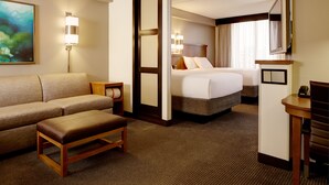 A hotel room with a sofa, a bed, a desk, and a TV. - Hyatt Place Fremont/Silicon Valley (Fremont)