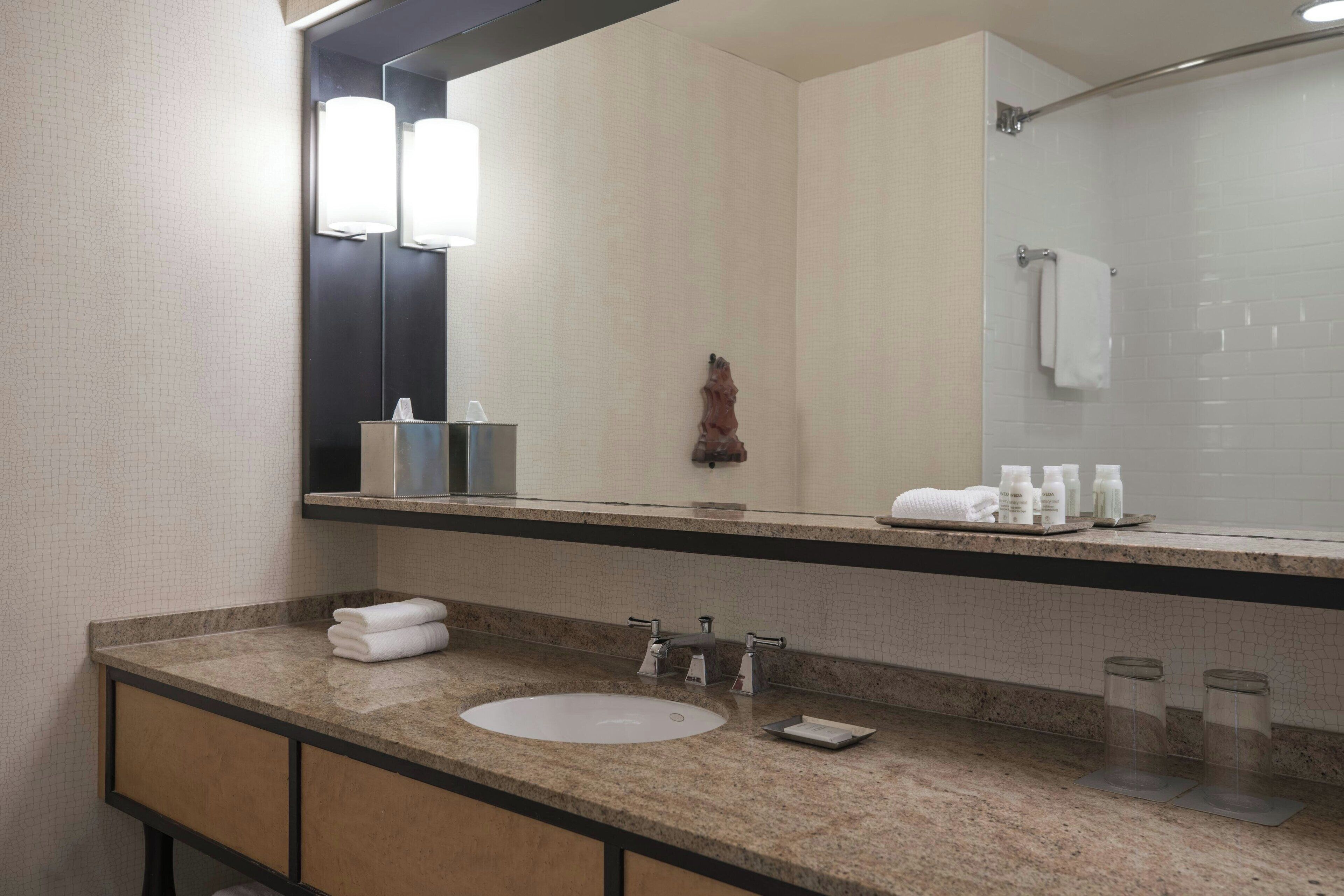 combined shower/bathtub, designer toiletries, hair dryer, towels