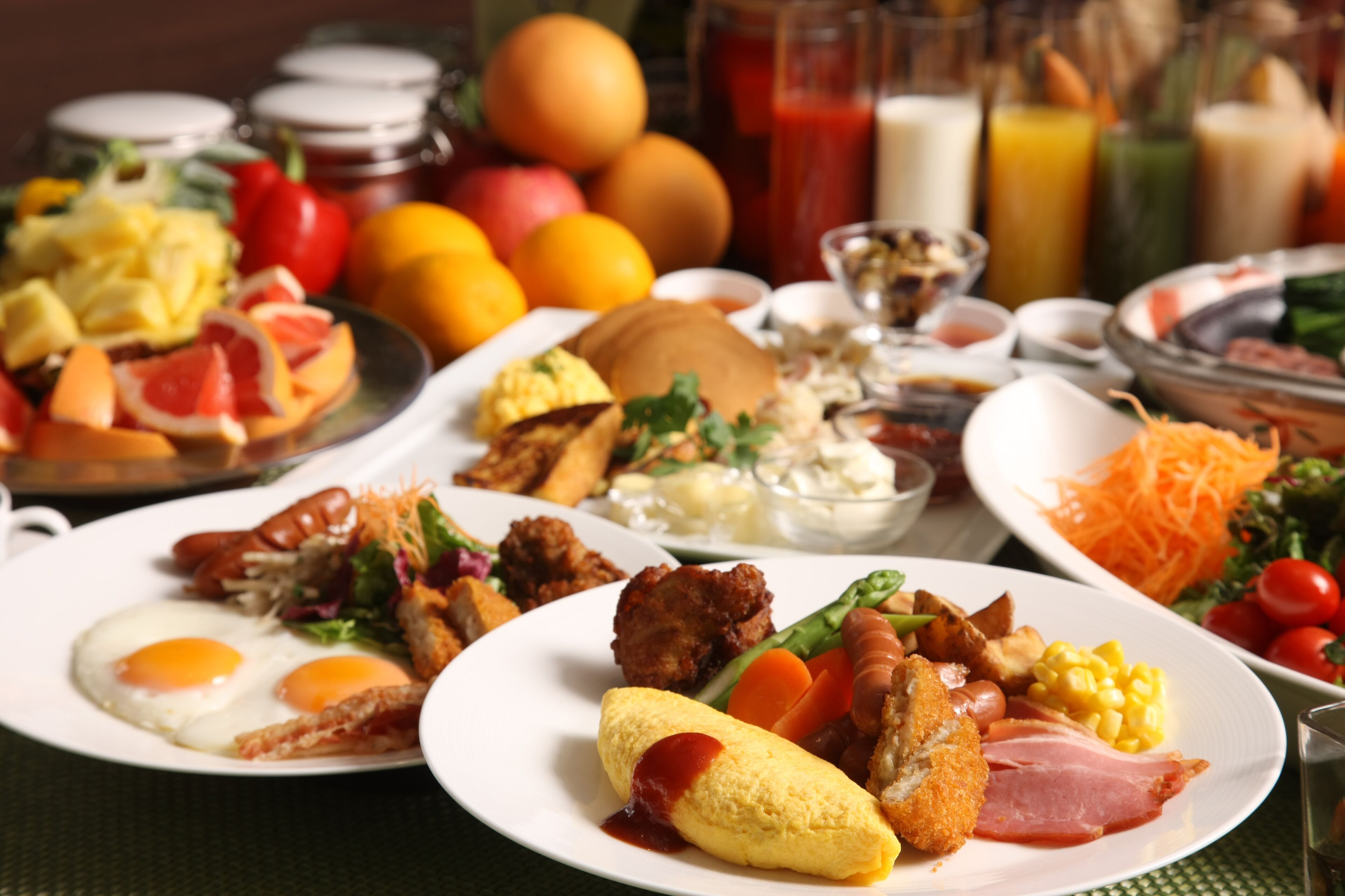 A breakfast buffet with various dishes including eggs, meats, and vegetables.