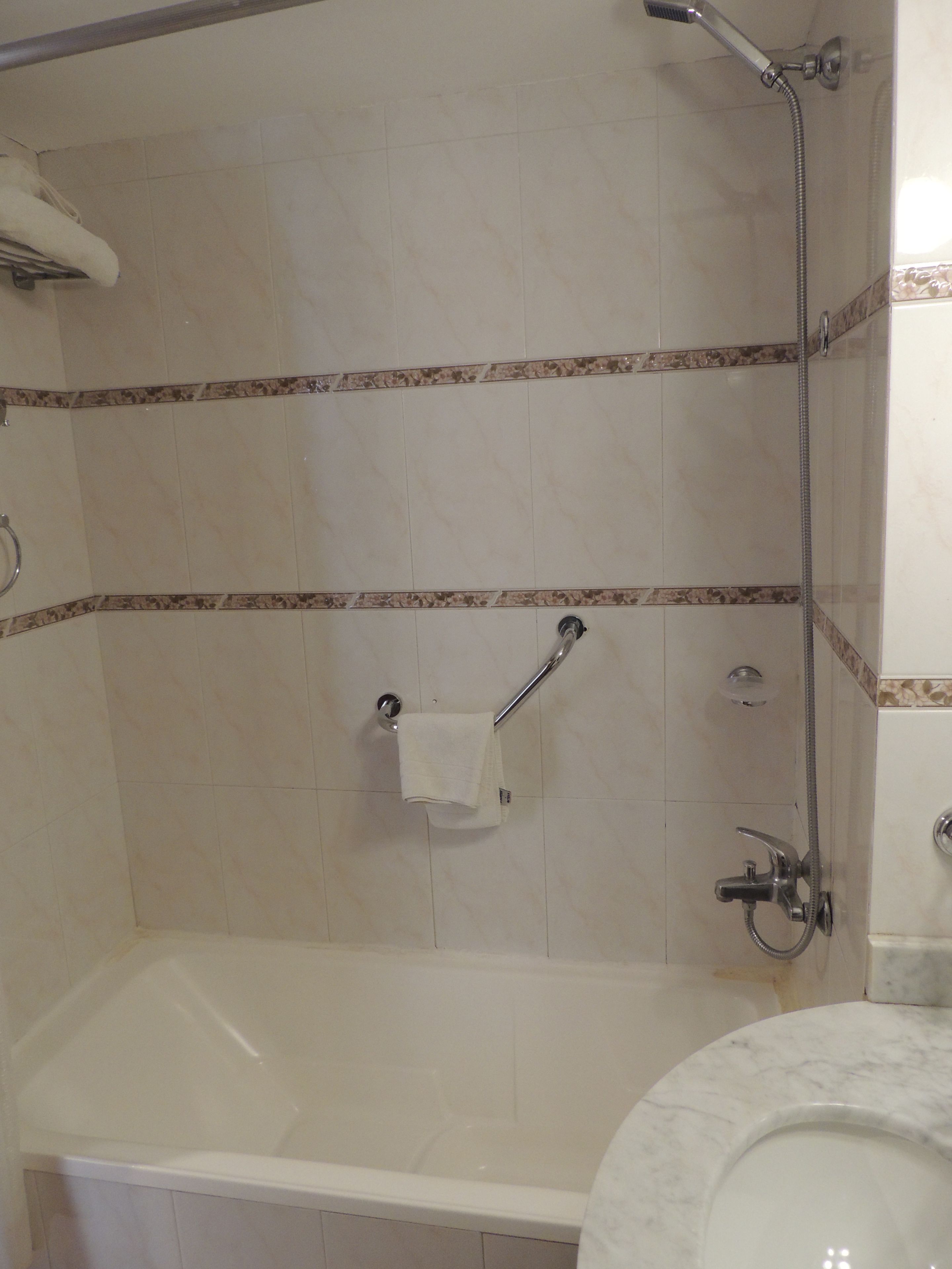 A bathroom with a bathtub, a shower, and a toilet.