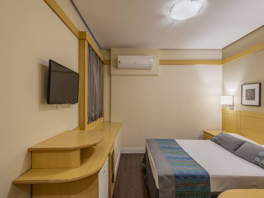 Standard Double Room | Minibar, in-room safe, desk, blackout drapes