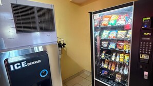 A vending machine with a freezer section and a beverage dispenser.