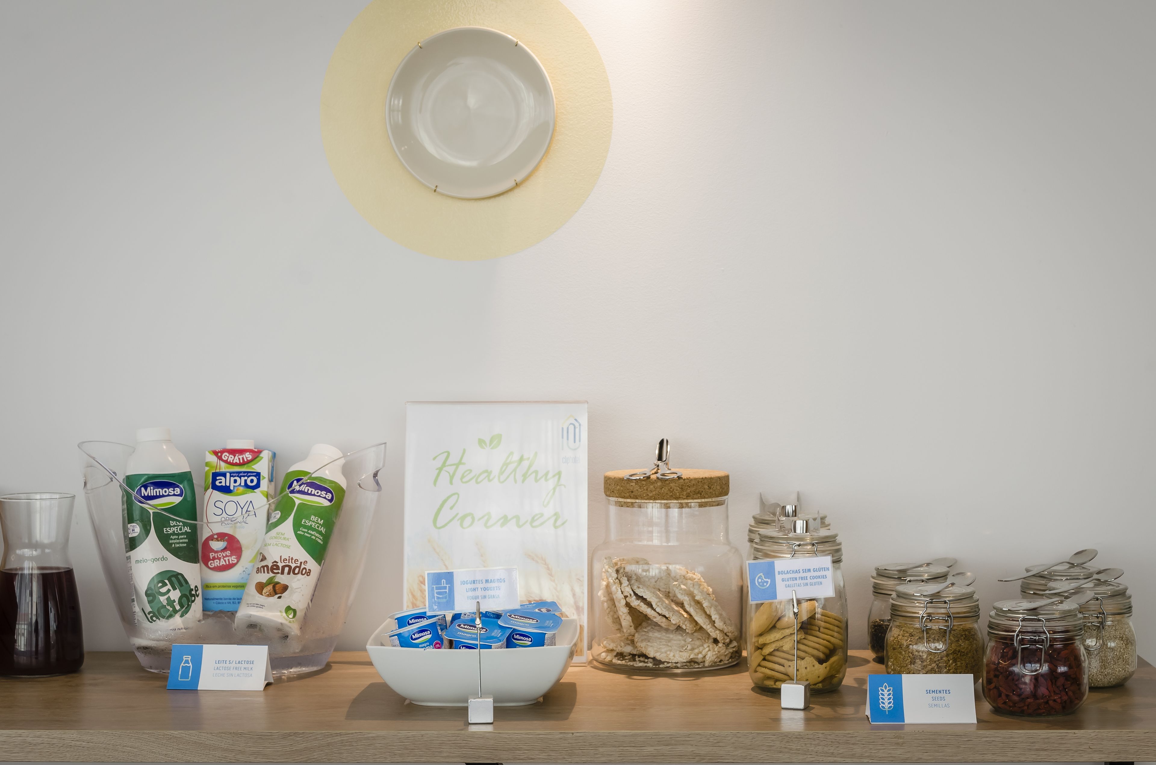A snack and beverage station with various dairy products, snacks, and condiments.