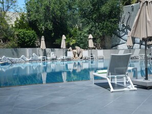 Seasonal outdoor pool, open 9:00 AM to 6:00 PM, pool umbrellas