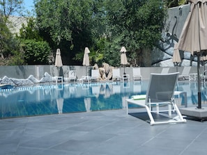 Seasonal outdoor pool, open 9:00 AM to 6:00 PM, pool umbrellas