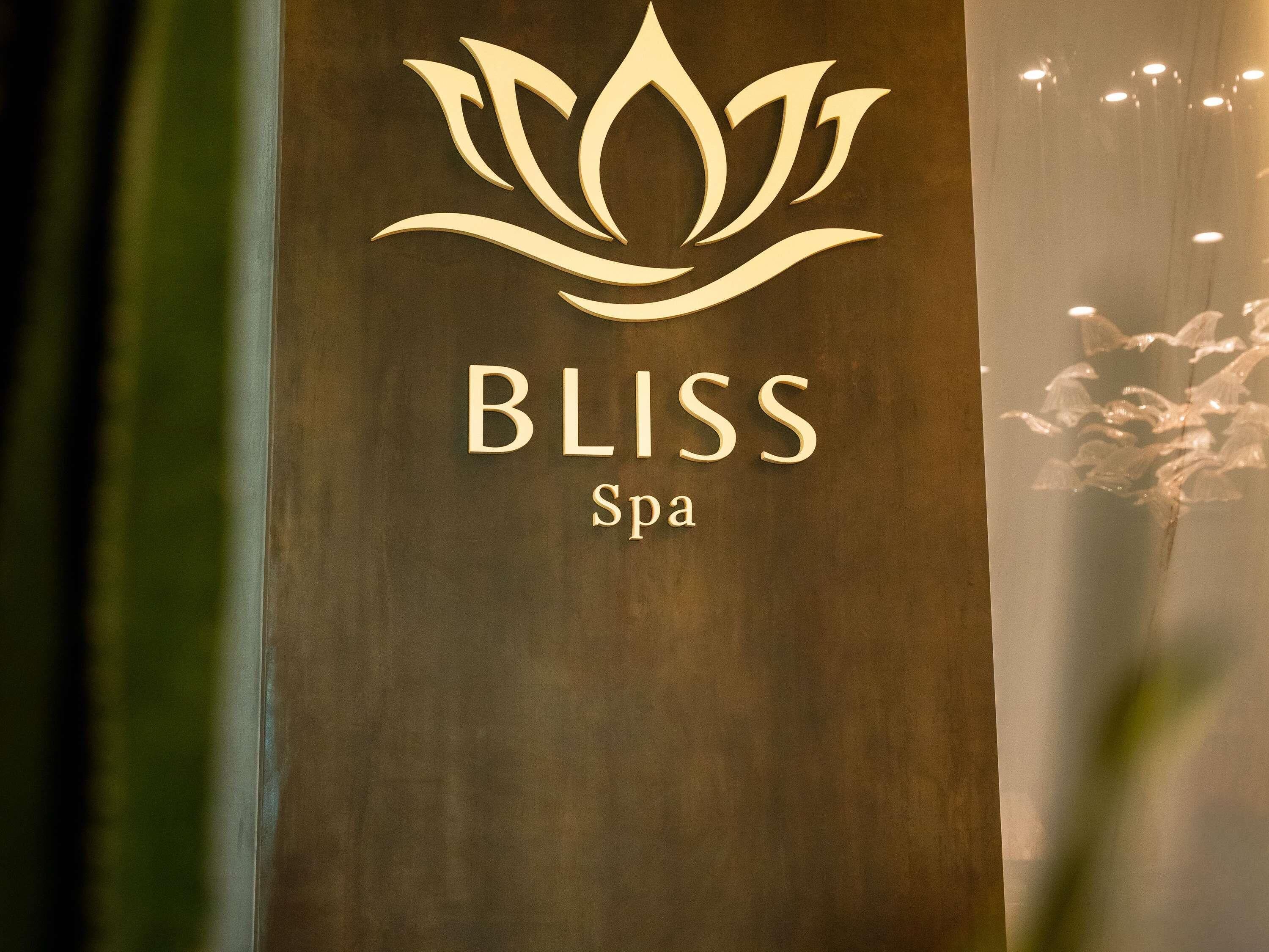 A logo with a lotus flower and the words 'BLISS Spa'.